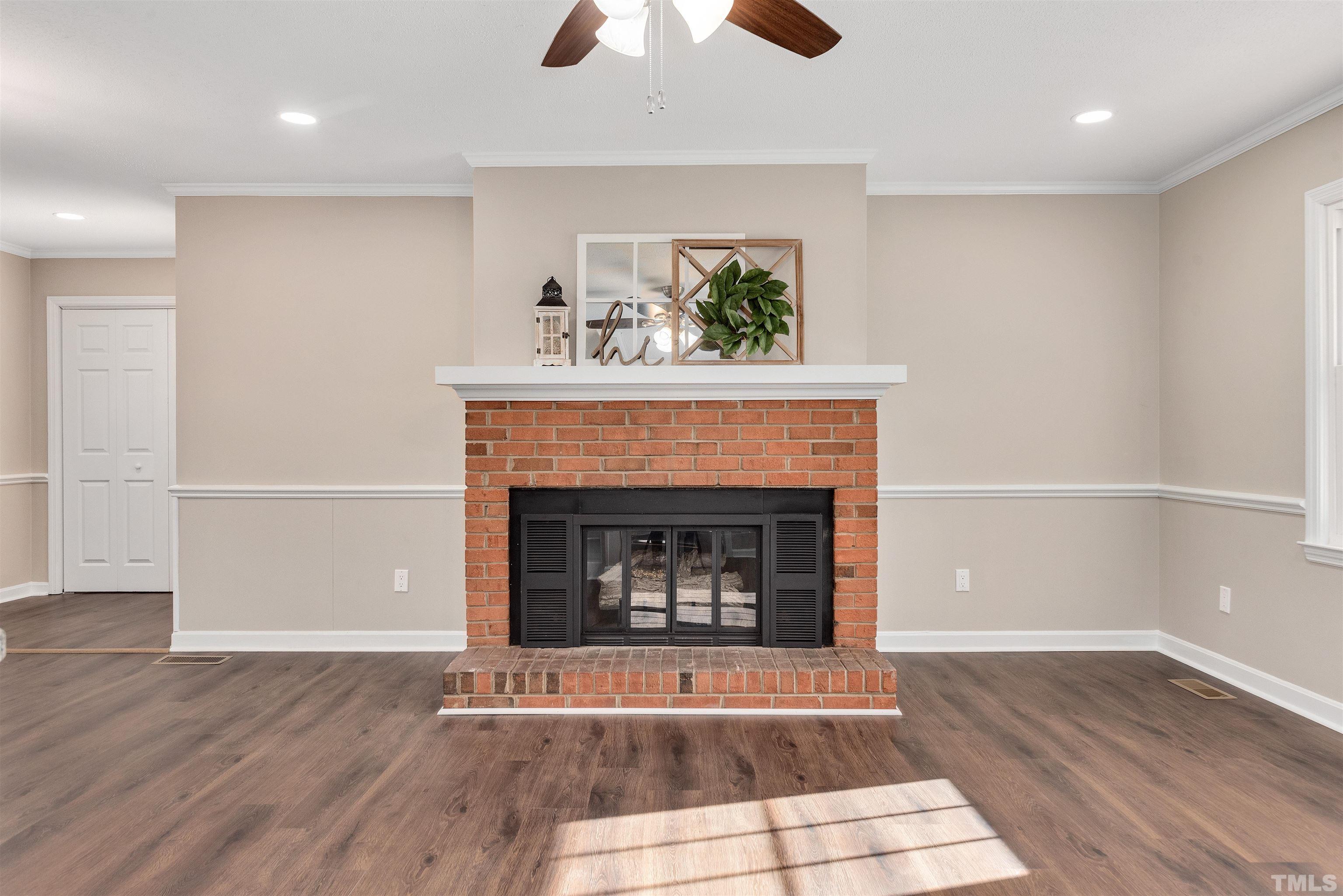 5630 Fairground Road Dunn, NC 28334 - Photo 4 of 33 a living room with a fireplace and wooden floor