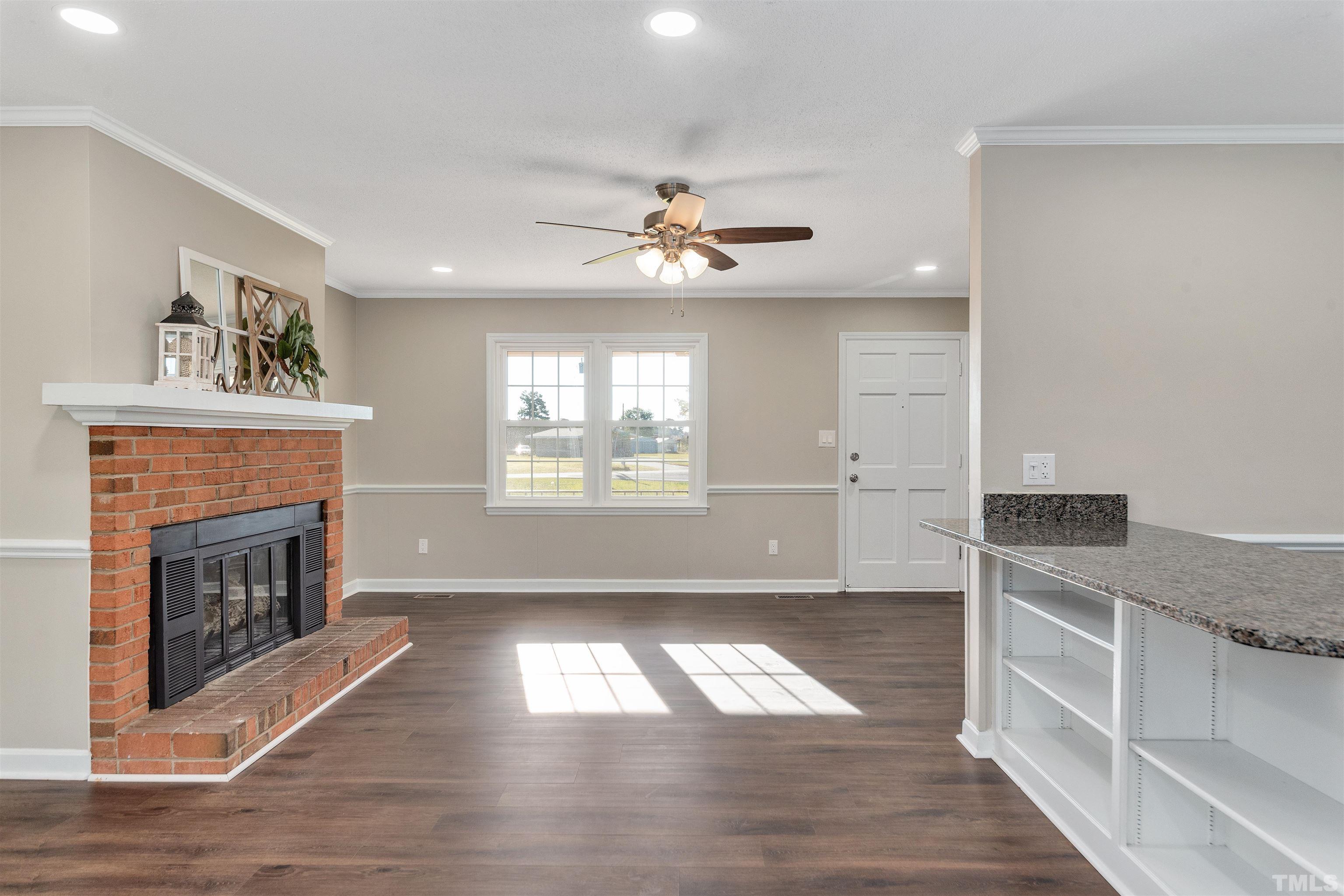 5630 Fairground Road Dunn, NC 28334 - Photo 5 of 33 a living room with furniture and a fireplace
