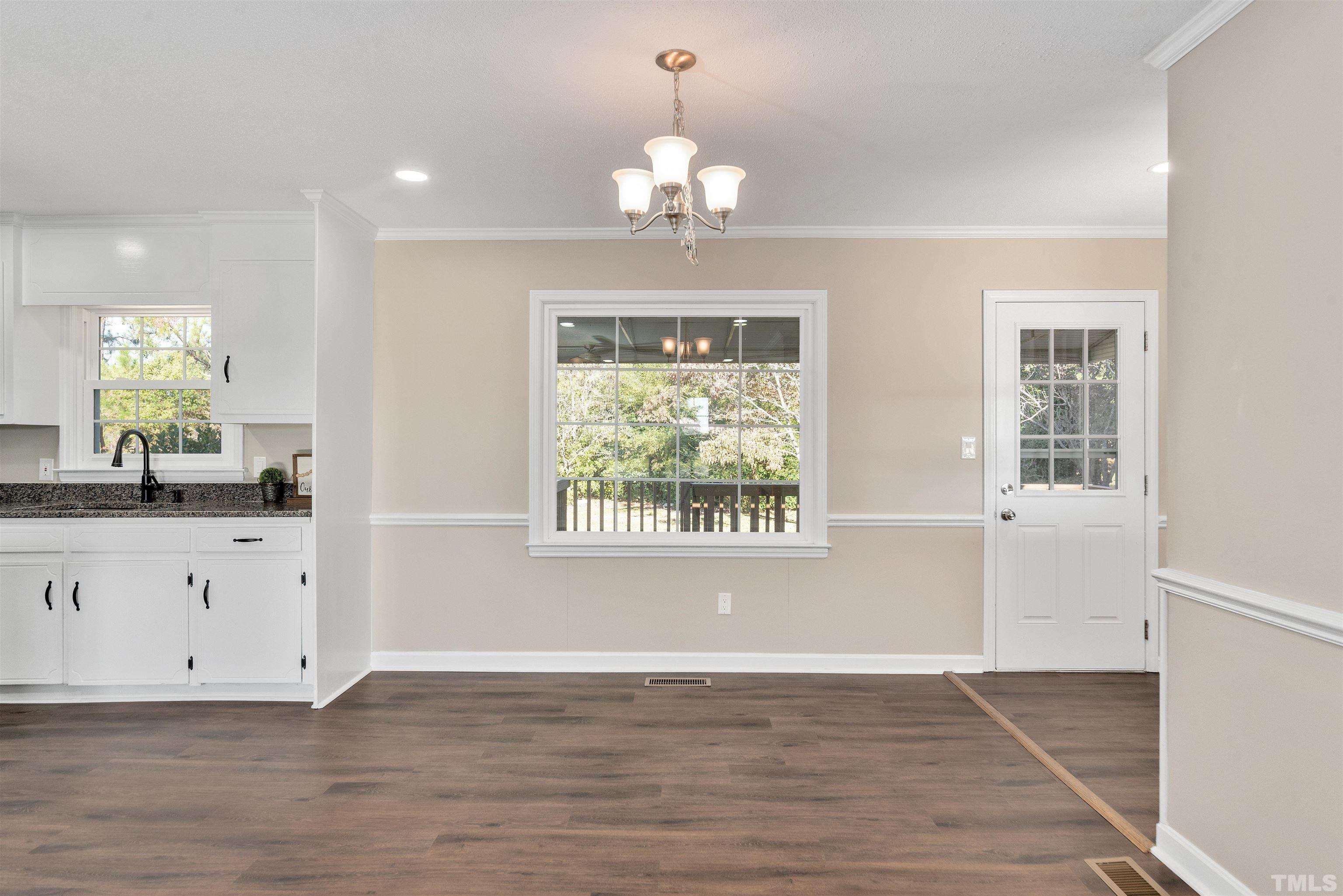 5630 Fairground Road Dunn, NC 28334 - Photo 8 of 33 an empty room with wooden floor and windows