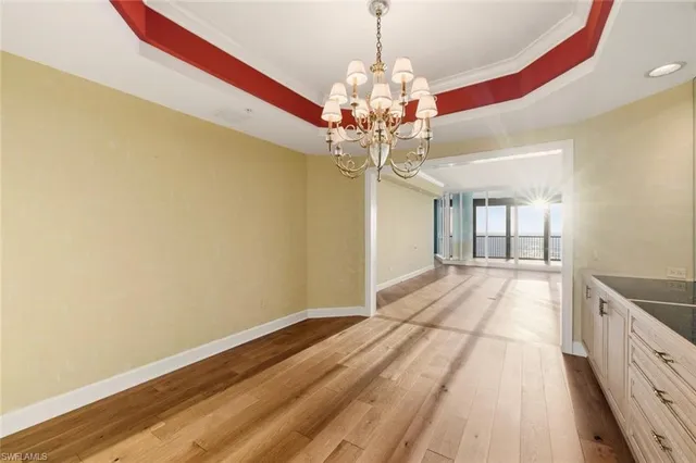 a view of a room with wooden floor and chandelier
