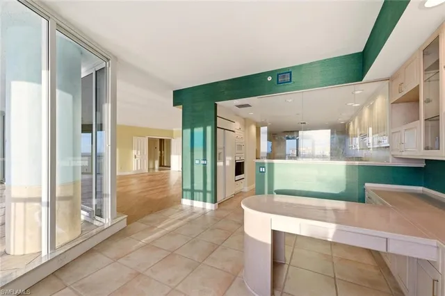 a kitchen with stainless steel appliances a sink and a refrigerator