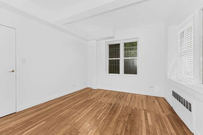2750 Johnson Avenue, Unit 3H Bronx, NY 10463 - Photo 6 of 12 Unfurnished room featuring radiator heating unit and wood finished floors