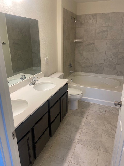 4631 Cullen Brook Road Katy, TX 77449 - Photo 5 of 15 a bathroom with a double vanity sink toilet mirror and bathtub