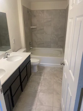 a bathroom with a sink a toilet and a bathtub