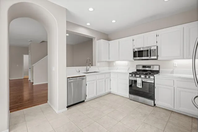 a kitchen with granite countertop cabinets and stainless steel appliances