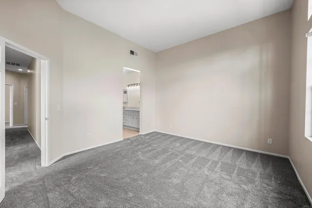 a spacious bathroom with double sink a large mirror and a bathtub