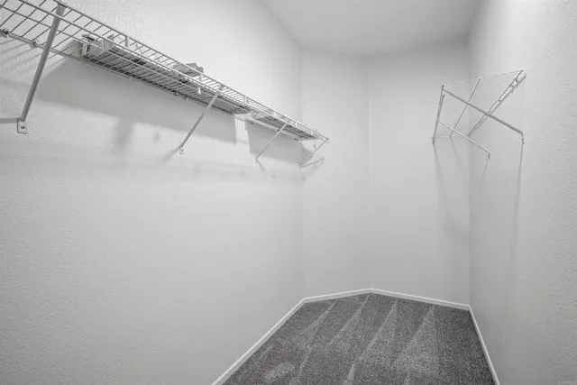 a backyard of a house with barbeque oven table and chairs