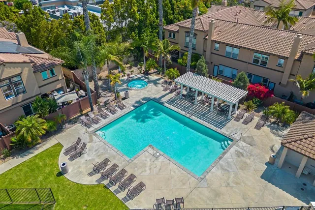 an aerial view of residential houses with outdoor space