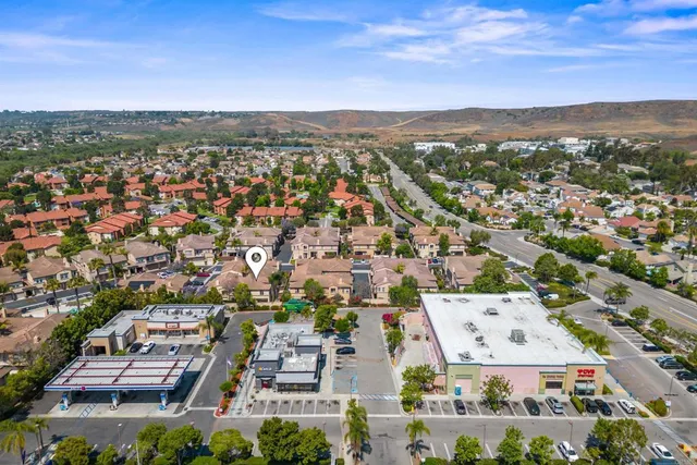 an aerial view of residential houses with city view