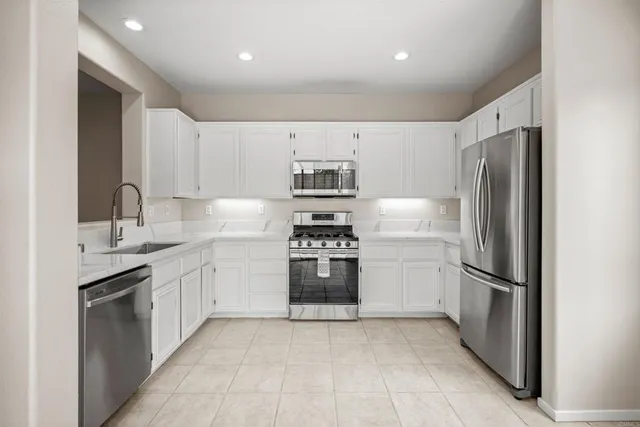 a kitchen with a refrigerator and a sink
