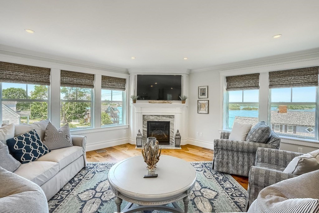 170 Otis Street Hingham, MA 02043 - Photo 11 of 24 a living room with furniture a fireplace and a flat screen tv