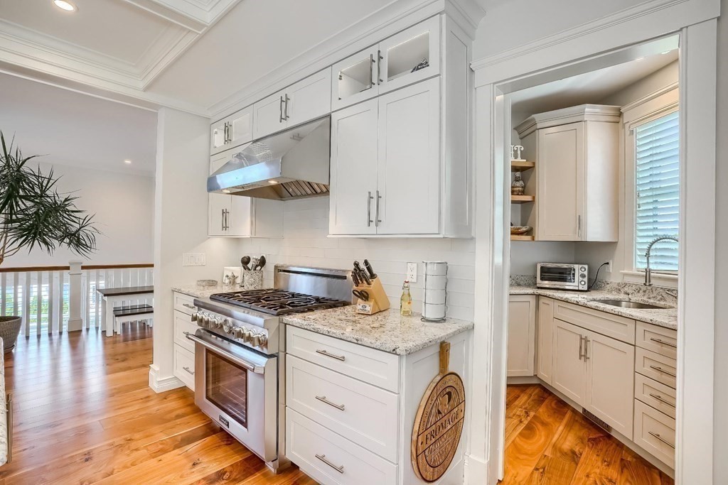 170 Otis Street Hingham, MA 02043 - Photo 13 of 24 a kitchen with stainless steel appliances granite countertop a stove a sink and a white cabinets