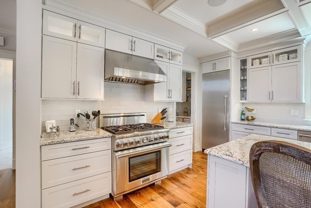 170 Otis Street Hingham, MA 02043 - Photo 14 of 24 a kitchen with stainless steel appliances granite countertop a stove and a refrigerator