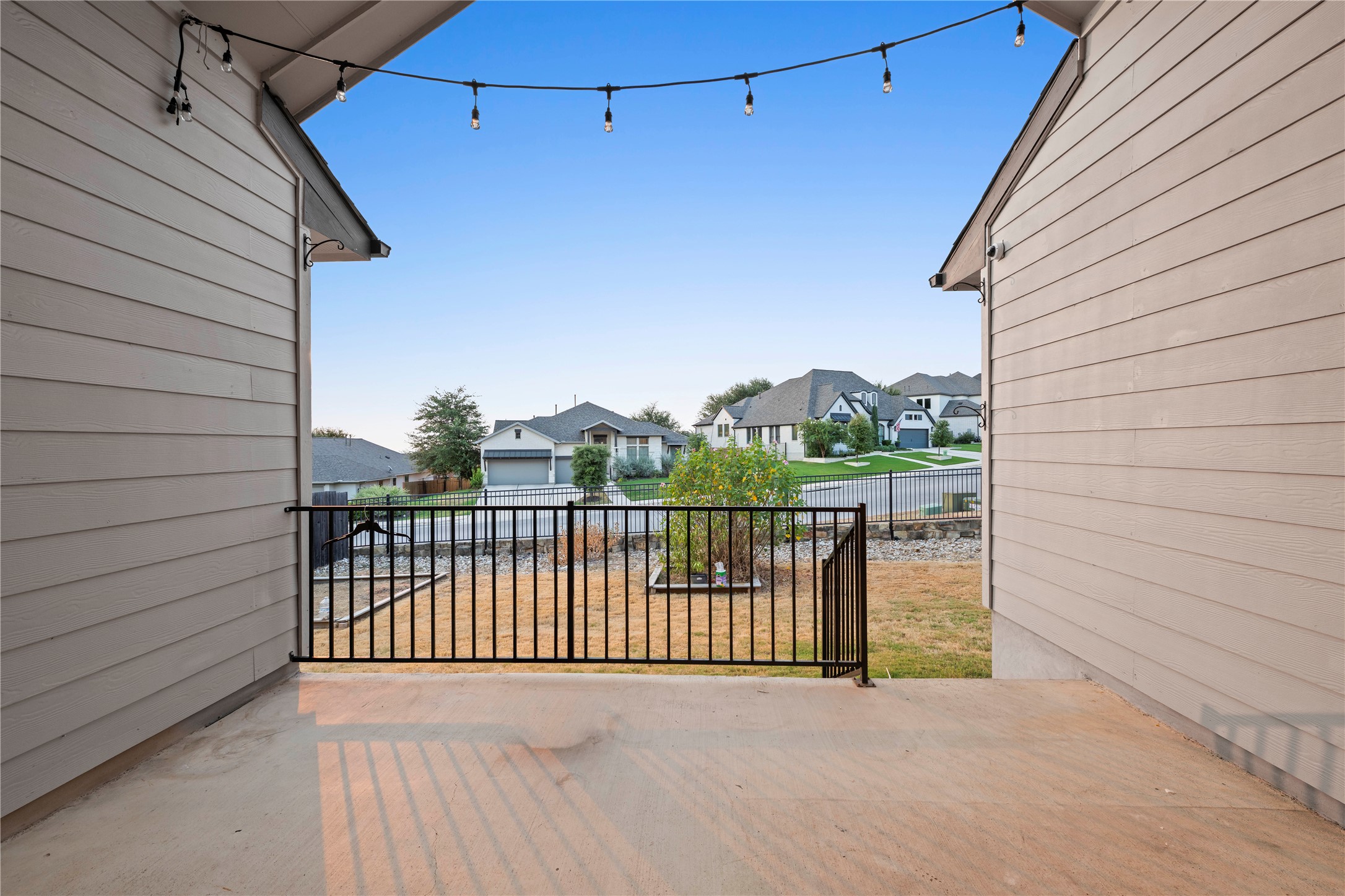 60 Rancho Trail Georgetown, TX 78628 - Photo 34 of 36 An elevated covered patio features horizontal siding, concrete flooring, and views of a fenced backyard.