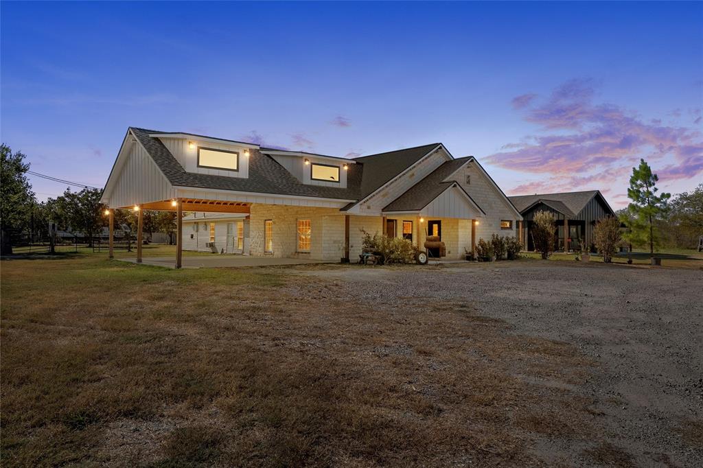 View of front of house with roof with shingles and a front yard