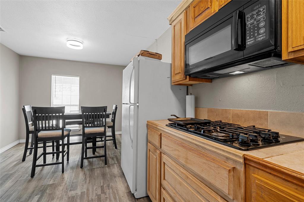 979 Old Mexia Road Waco, TX 76705 - Photo 16 of 40 a kitchen with a stove a microwave and cabinets
