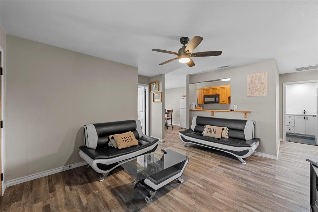 979 Old Mexia Road Waco, TX 76705 - Photo 5 of 40 a living room with furniture a flat screen tv and a fireplace