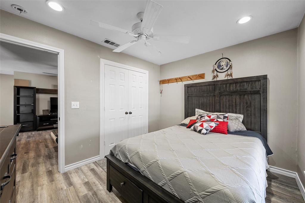 979 Old Mexia Road Waco, TX 76705 - Photo 10 of 40 a bedroom with a bed and a chandelier