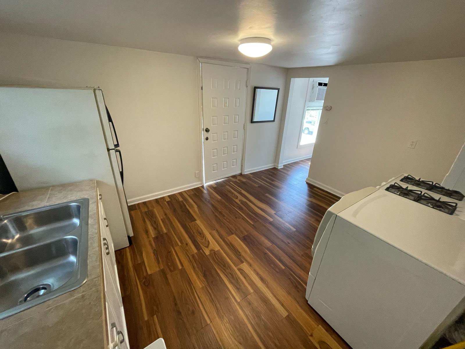6404 Ponca Street, Unit B Austin, TX 78741 - Photo 3 of 17 a hallway view with wooden floor and staircase