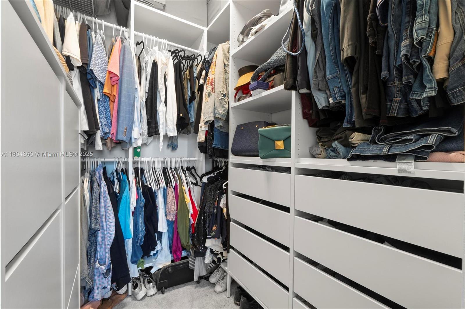 23517 Southwest 127th Place Homestead, FL 33032 - Photo 17 of 28 a view of walk in closet with clothes and shoes