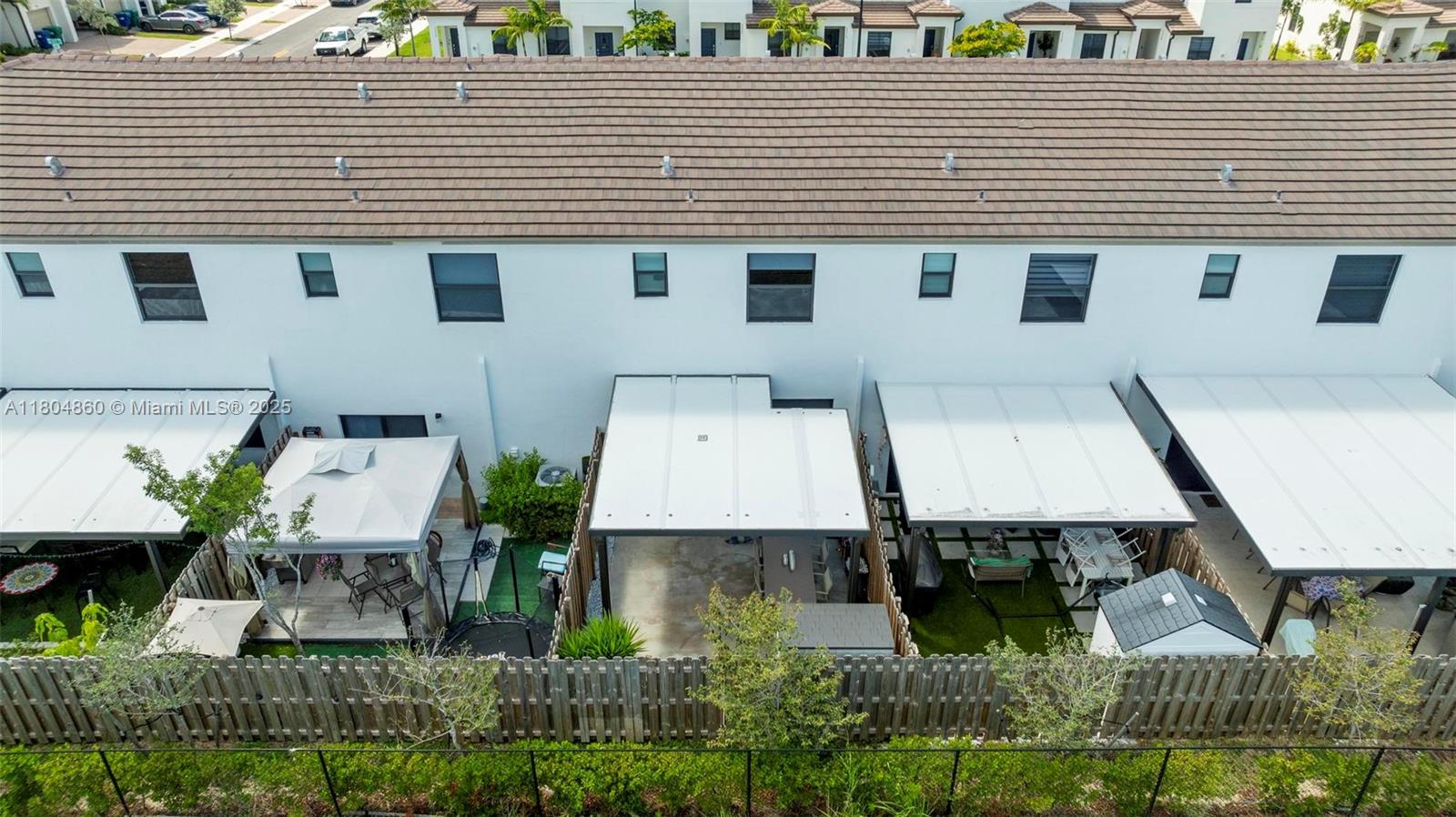 23517 Southwest 127th Place Homestead, FL 33032 - Photo 20 of 28 a aerial view of a house with large trees and lawn chairs