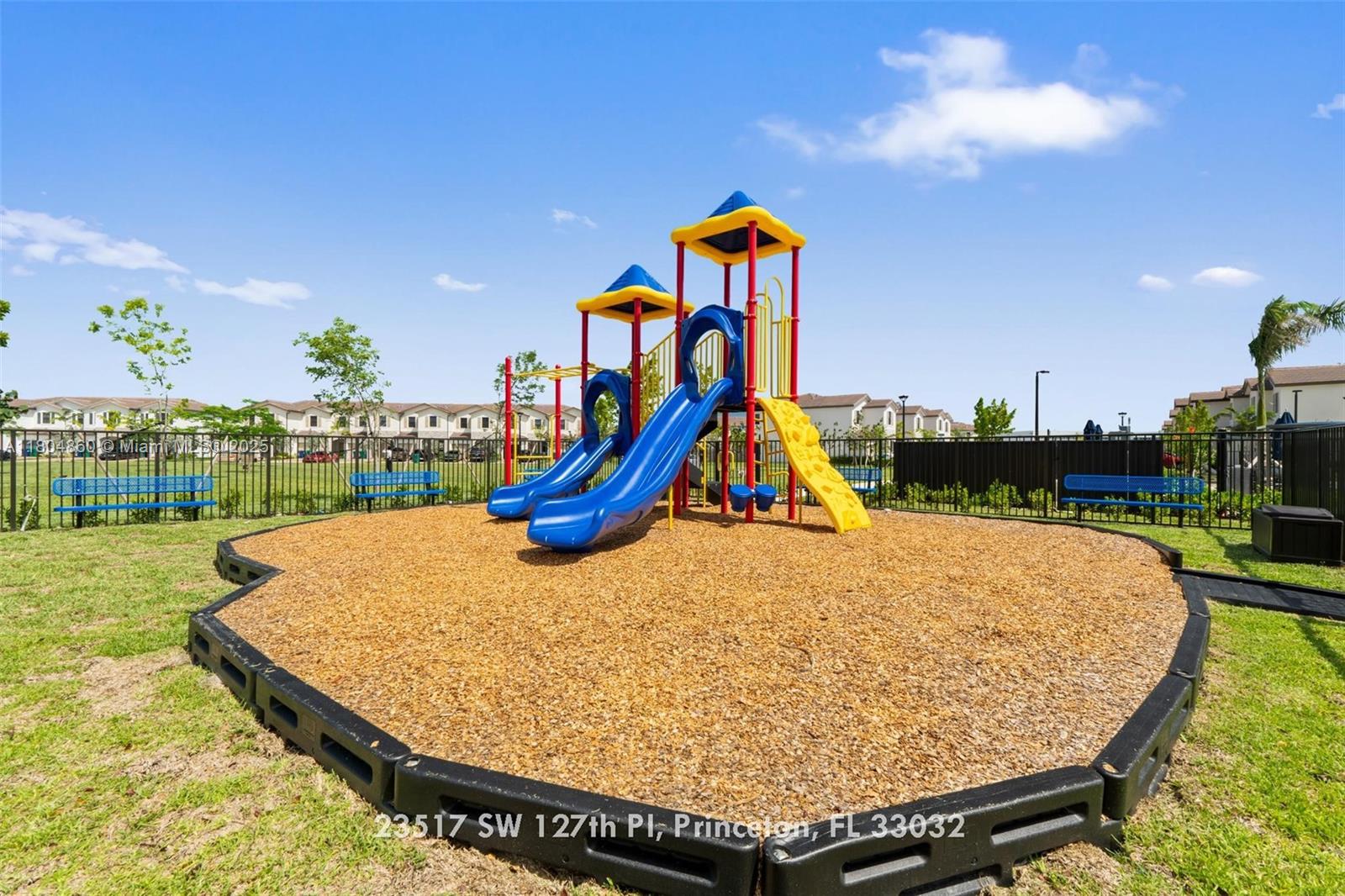 23517 Southwest 127th Place Homestead, FL 33032 - Photo 27 of 28 a view of a park with swings and slides
