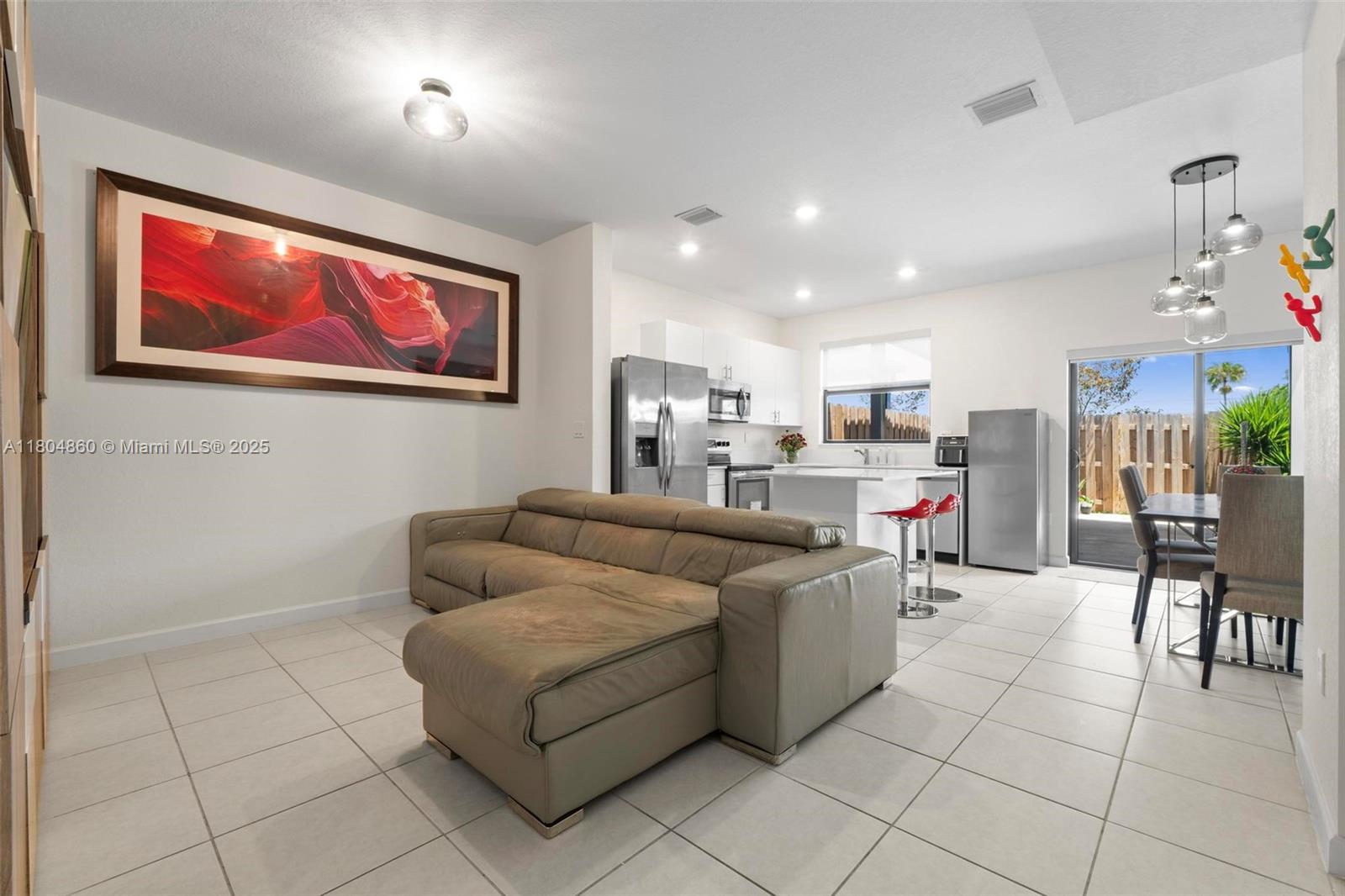 23517 Southwest 127th Place Homestead, FL 33032 - Photo 5 of 28 a living room with furniture and kitchen view