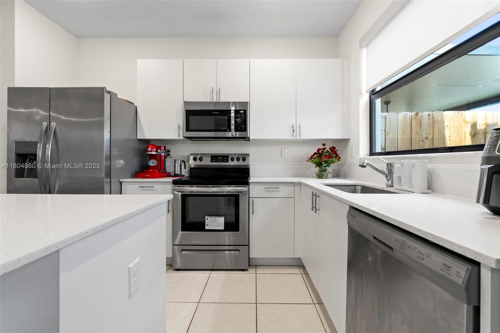 23517 Southwest 127th Place Homestead, FL 33032 - Photo 7 of 28 a kitchen with cabinets a sink and stainless steel appliances