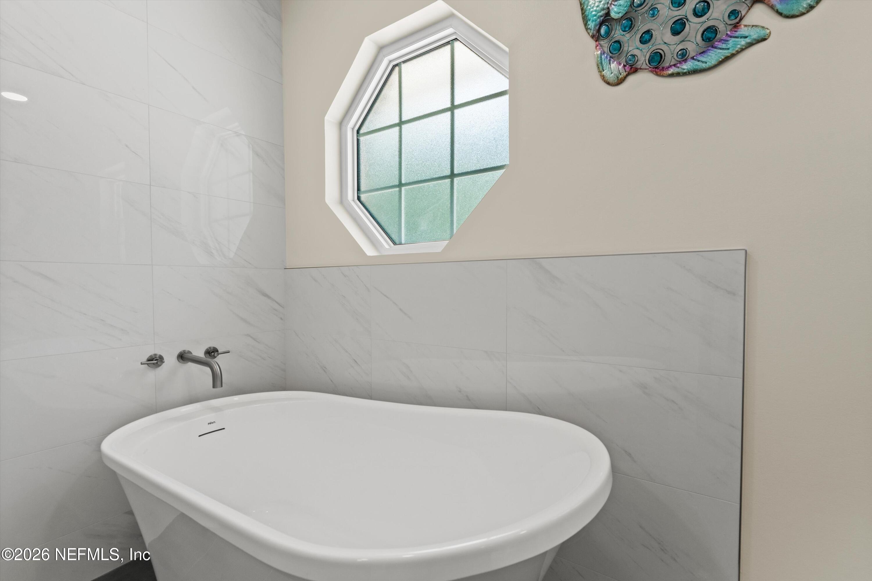 5566 Don Manuel Road Elkton, FL 32033 - Photo 21 of 47 a white bath tub sitting in a bathroom