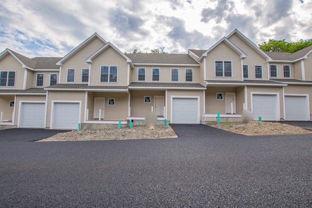 58 Reed Avenue, Unit 8 North Attleboro, MA 02760 - Photo 2 of 3 a front view of a house with a yard