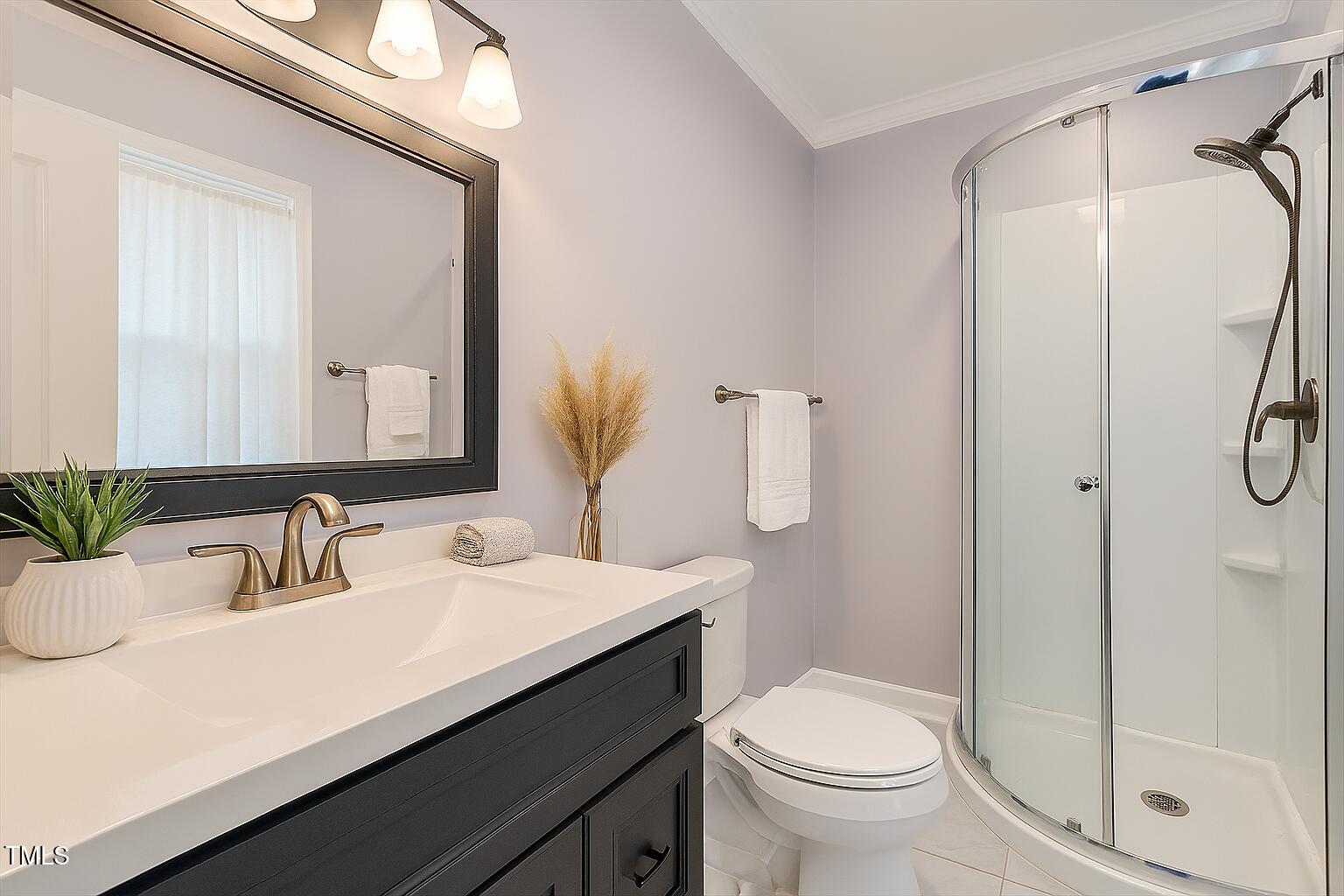1813 Grady Drive Durham, NC 27712 - Photo 13 of 32 a bathroom with a sink a toilet and shower