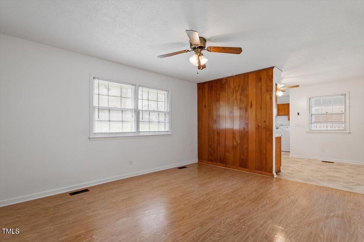1813 Grady Drive Durham, NC 27712 - Photo 17 of 32 a view of empty room with wooden floor and fan