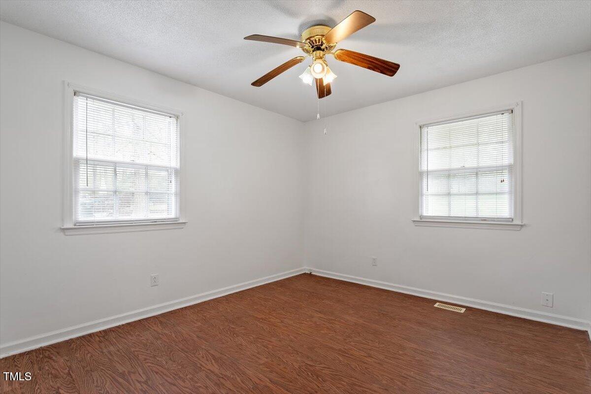 1813 Grady Drive Durham, NC 27712 - Photo 20 of 32 an empty room with wooden floor and windows