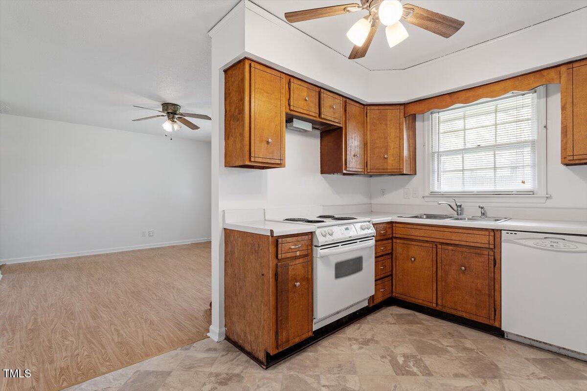 1813 Grady Drive Durham, NC 27712 - Photo 26 of 32 a kitchen with stainless steel appliances granite countertop a sink and a stove next to a window