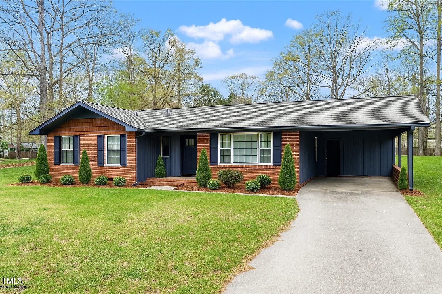 1813 Grady Drive Durham, NC 27712 - Photo 30 of 32 a view of a house with a yard and large tree