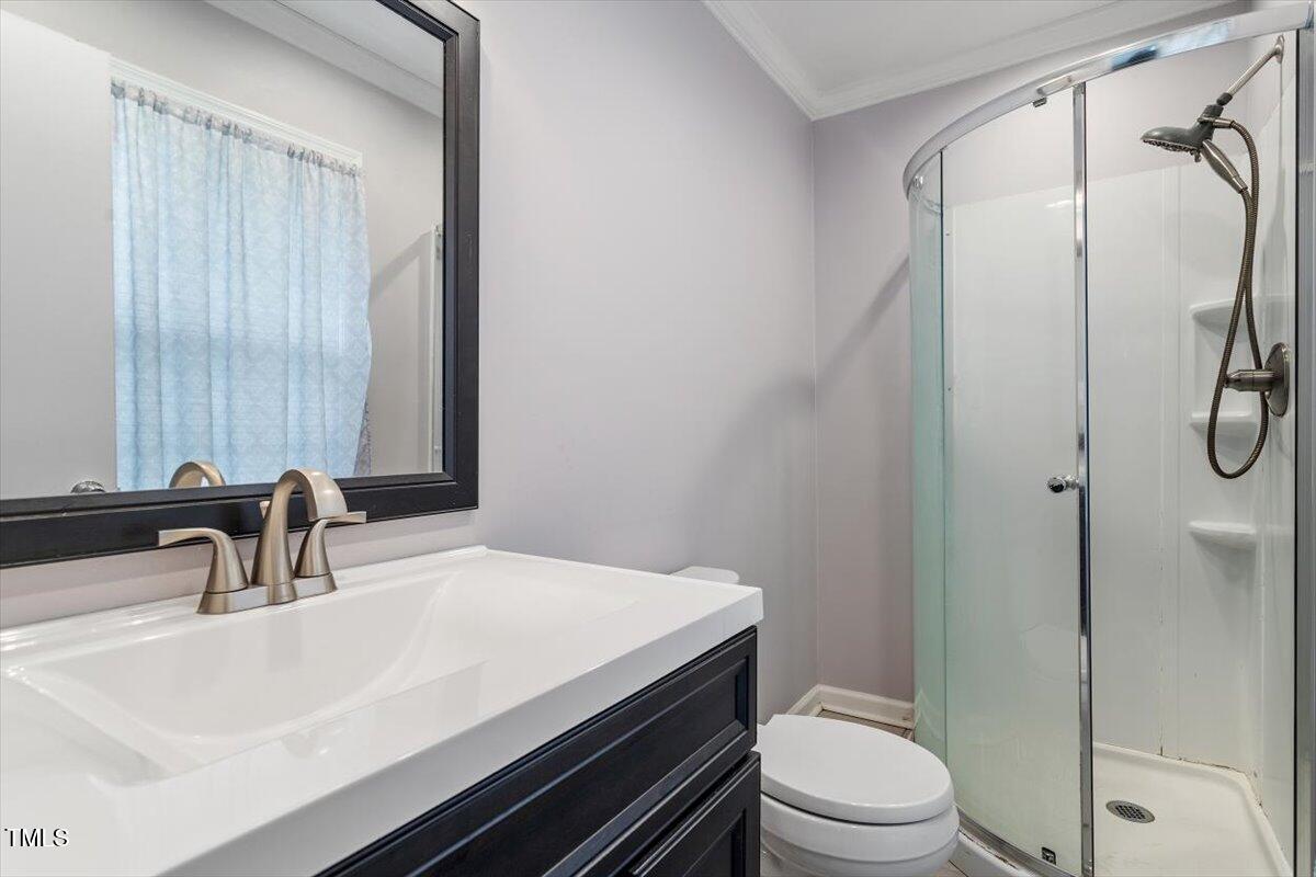 1813 Grady Drive Durham, NC 27712 - Photo 32 of 32 a bathroom with a sink and a toilet