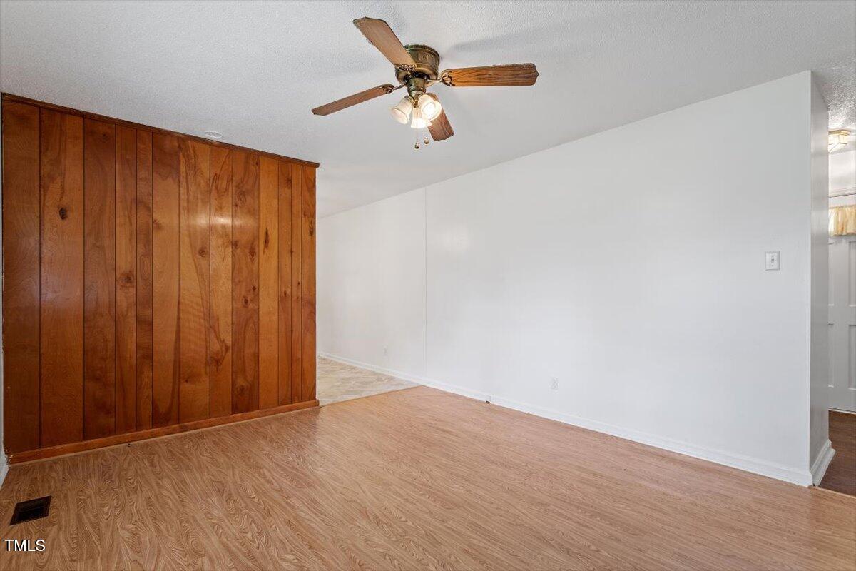 1813 Grady Drive Durham, NC 27712 - Photo 5 of 32 a view of an empty room with wooden floor