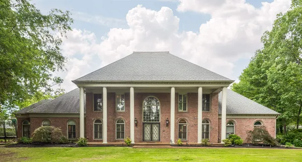 a front view of a house with a yard