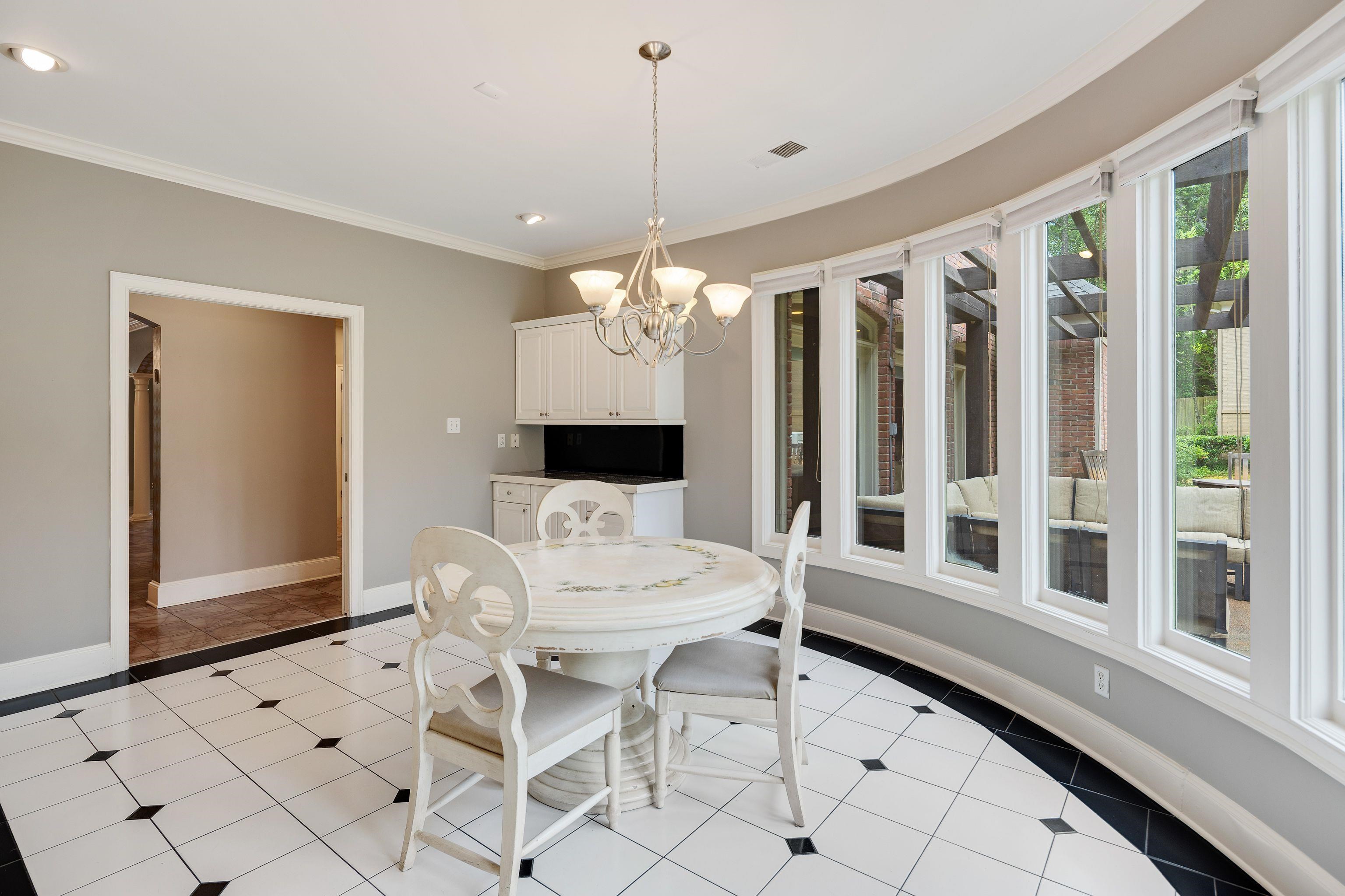 415 South Yates Road Memphis, TN 38120 - Photo 13 of 30 a dining room with furniture a chandelier and window