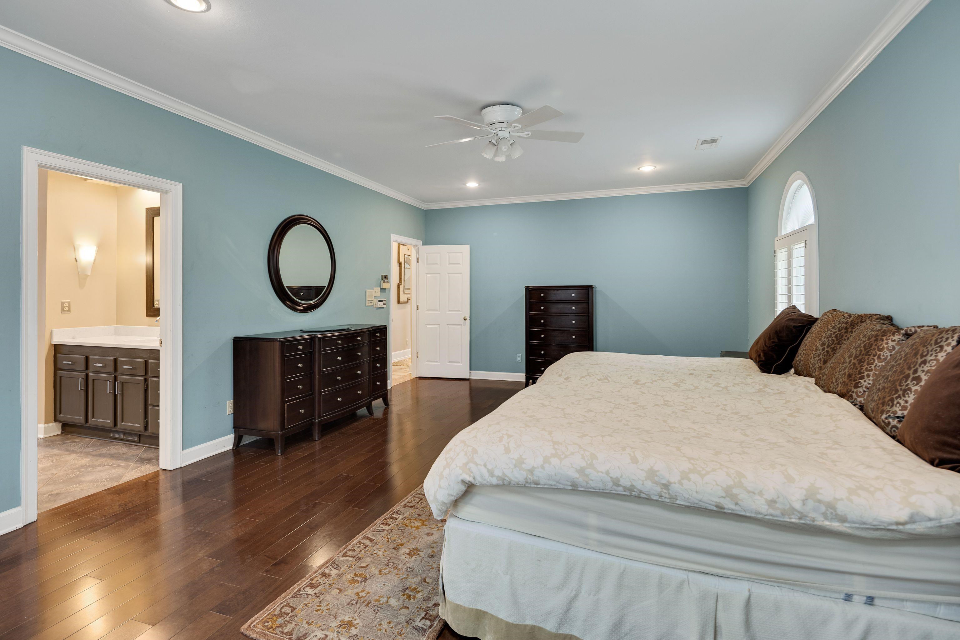 415 South Yates Road Memphis, TN 38120 - Photo 15 of 30 a spacious bedroom with a bed a dresser and wooden floor