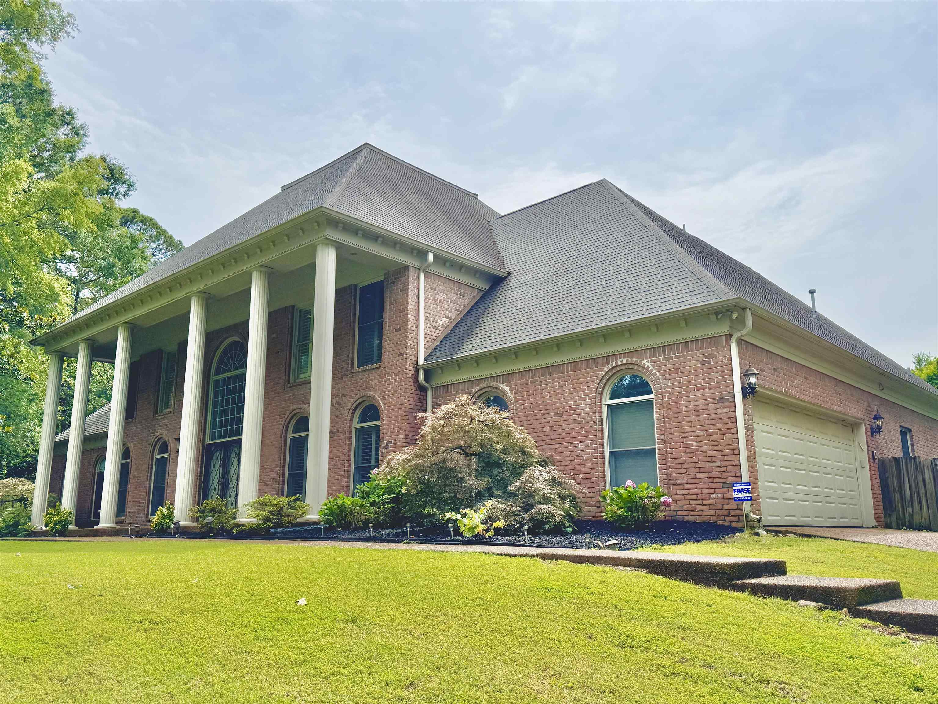 415 South Yates Road Memphis, TN 38120 - Photo 2 of 30 View of front of house with brick siding, a front lawn, and roof with shingles