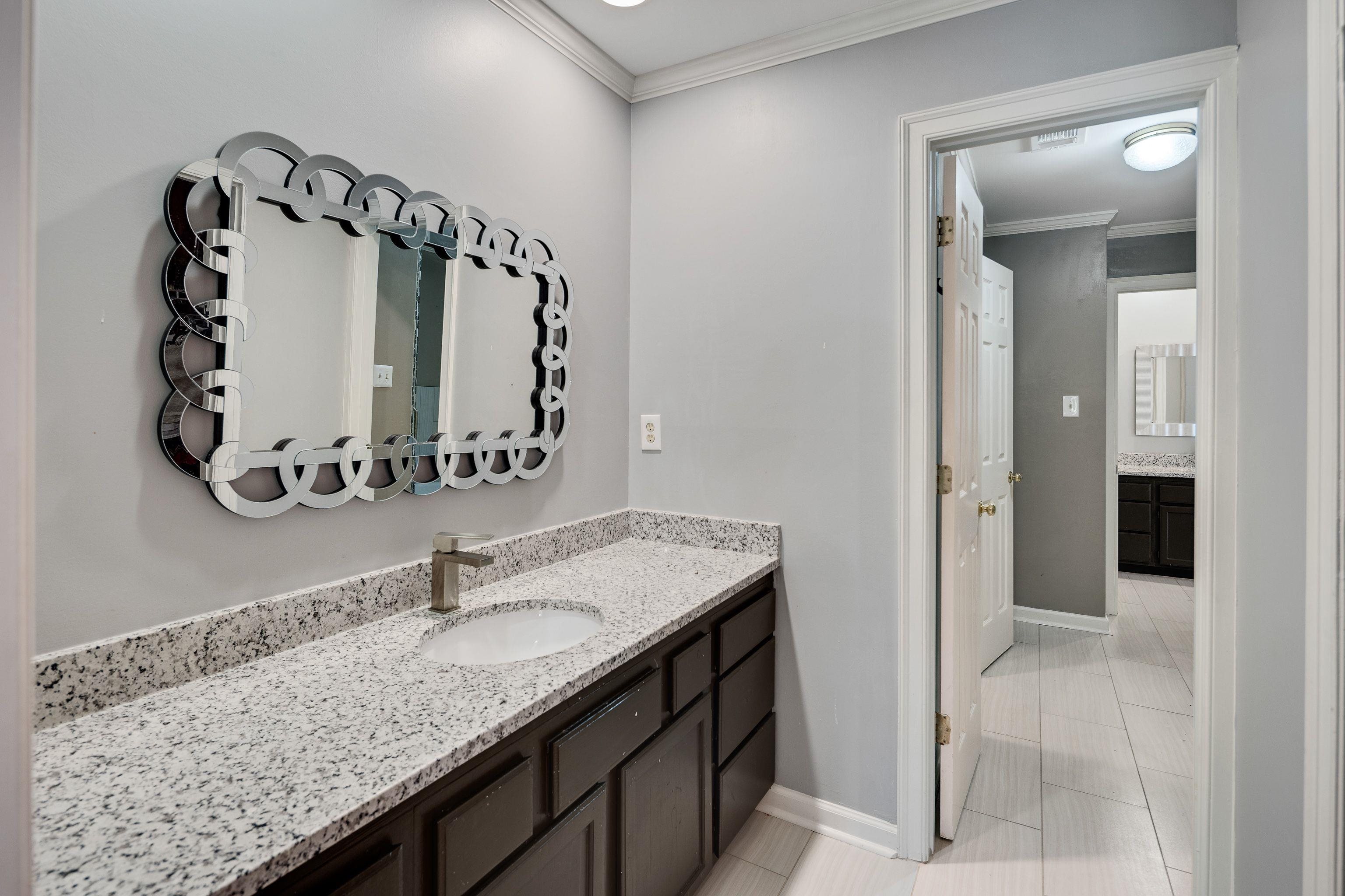 415 South Yates Road Memphis, TN 38120 - Photo 21 of 30 a bathroom with a granite countertop sink and a mirror