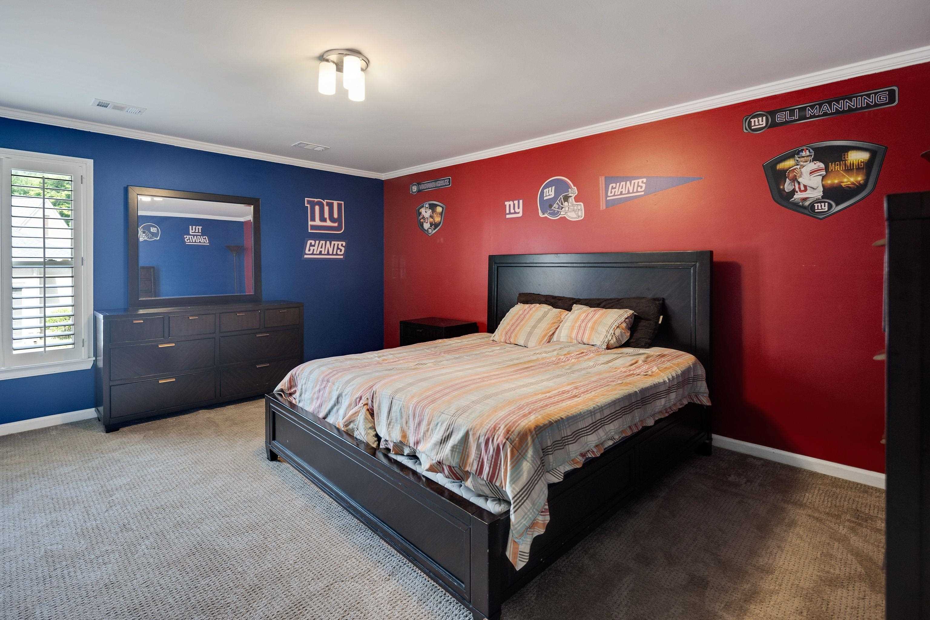 415 South Yates Road Memphis, TN 38120 - Photo 22 of 30 a bed sitting in a bedroom next to a window