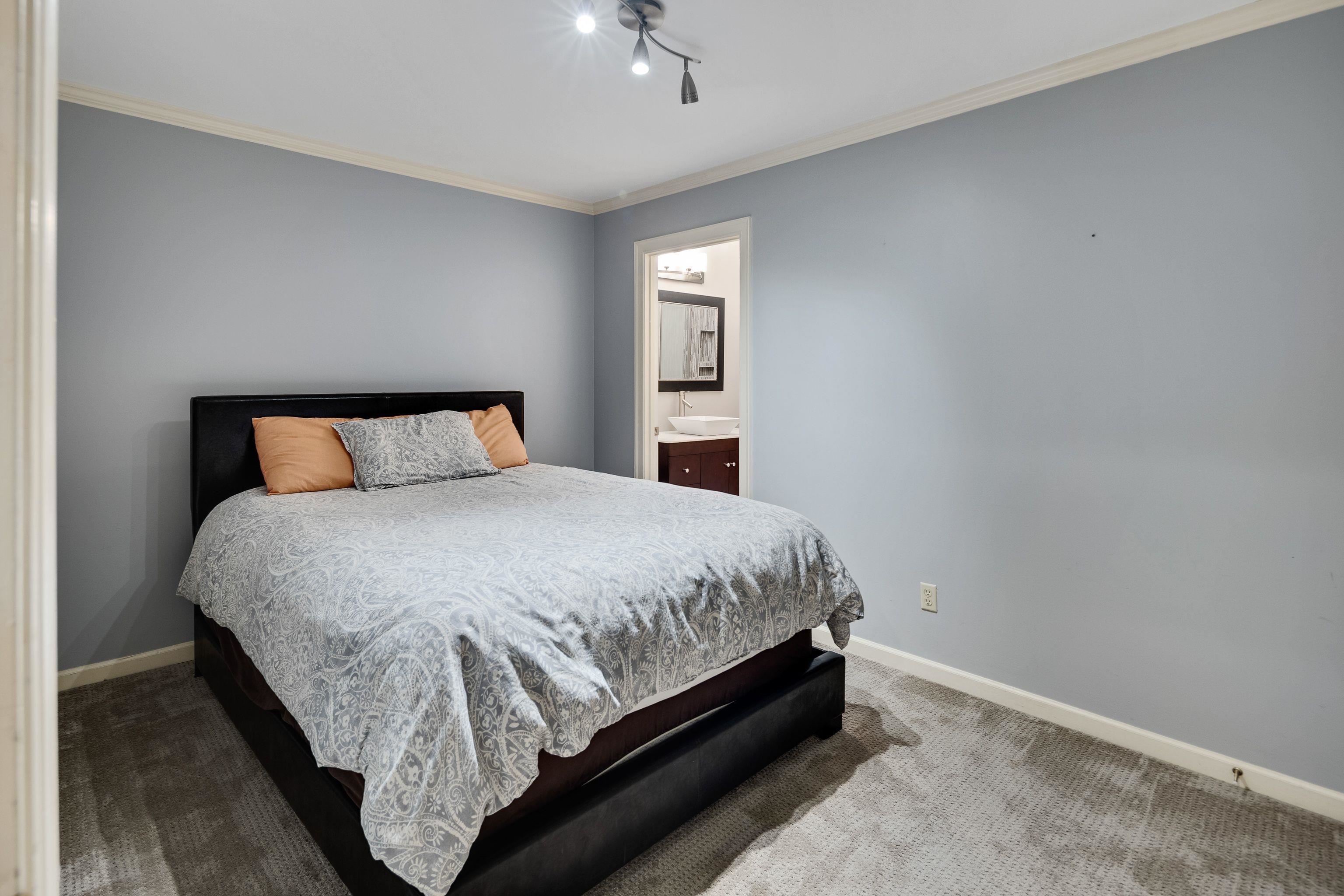 415 South Yates Road Memphis, TN 38120 - Photo 26 of 30 a bed sitting in a bedroom next to a window