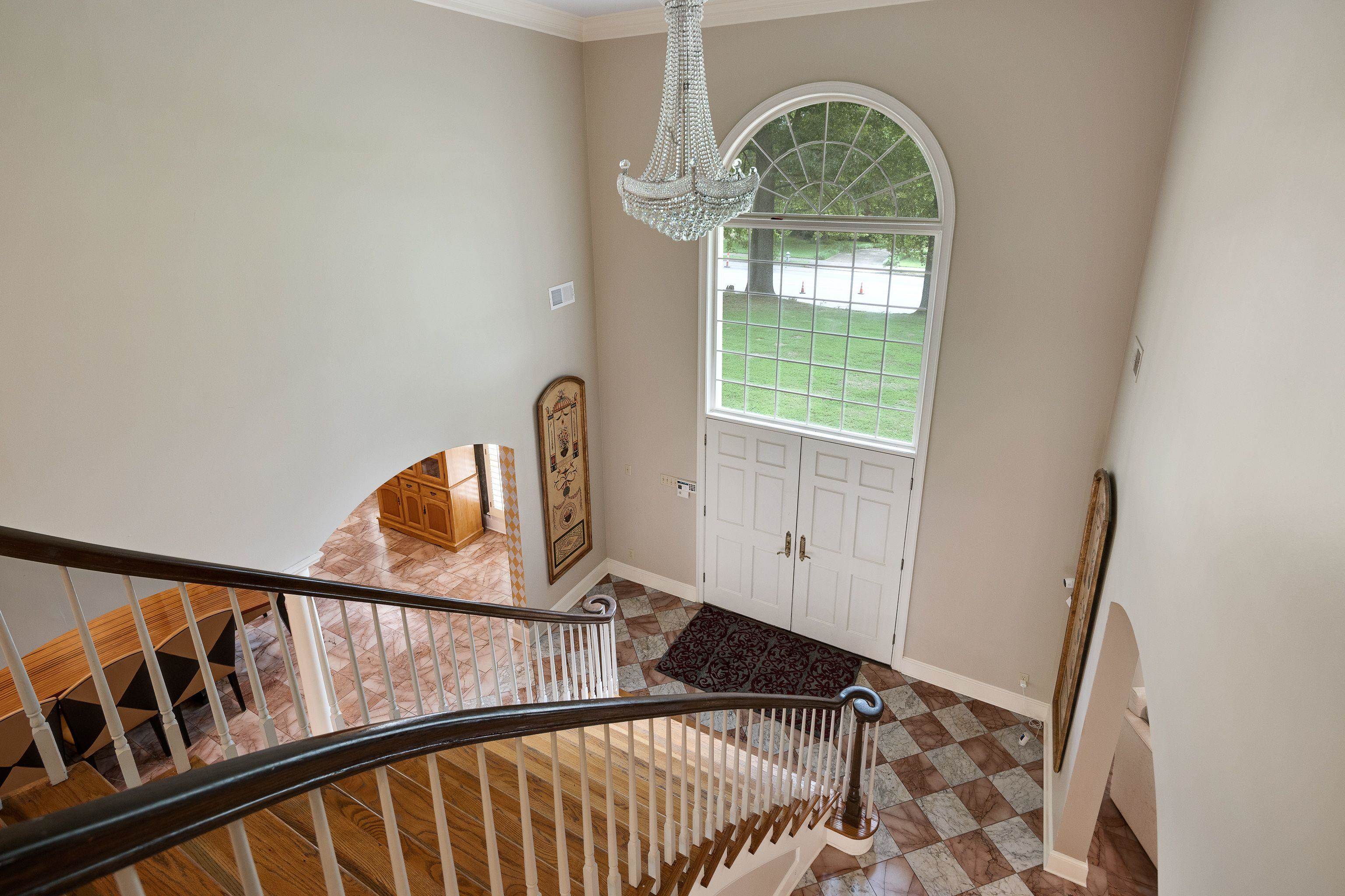 415 South Yates Road Memphis, TN 38120 - Photo 9 of 30 Foyer with a chandelier, baseboards, ornamental molding, and stairway