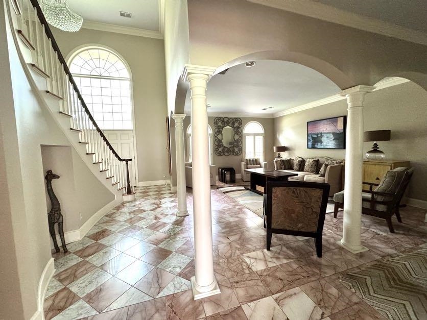 415 South Yates Road Memphis, TN 38120 - Photo 10 of 30 Entryway with arched walkways, decorative columns, stairs, ornamental molding, and baseboards