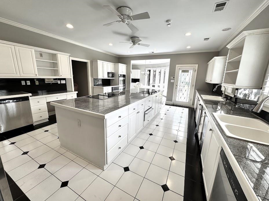 415 South Yates Road Memphis, TN 38120 - Photo 10 of 30 a large white kitchen with a stove a sink a washer and dryer