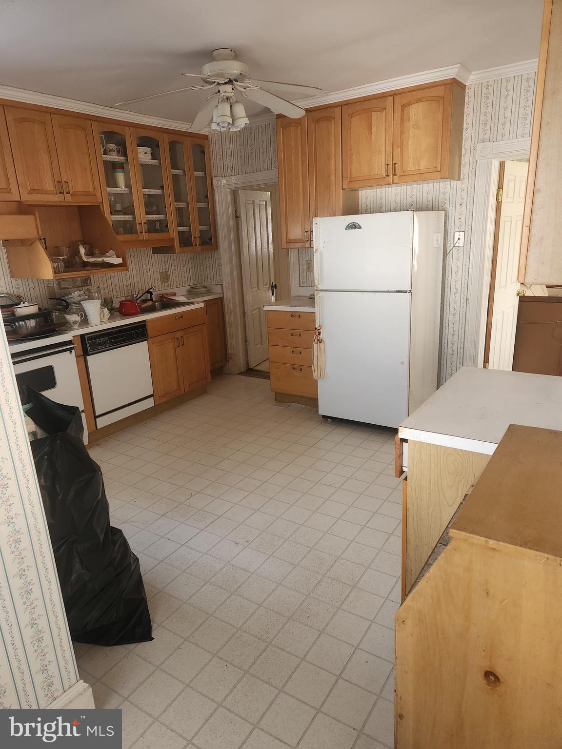 20538 Nanticoke Road Nanticoke, MD 21840 - Photo 21 of 24 a kitchen with a refrigerator and a stove top oven