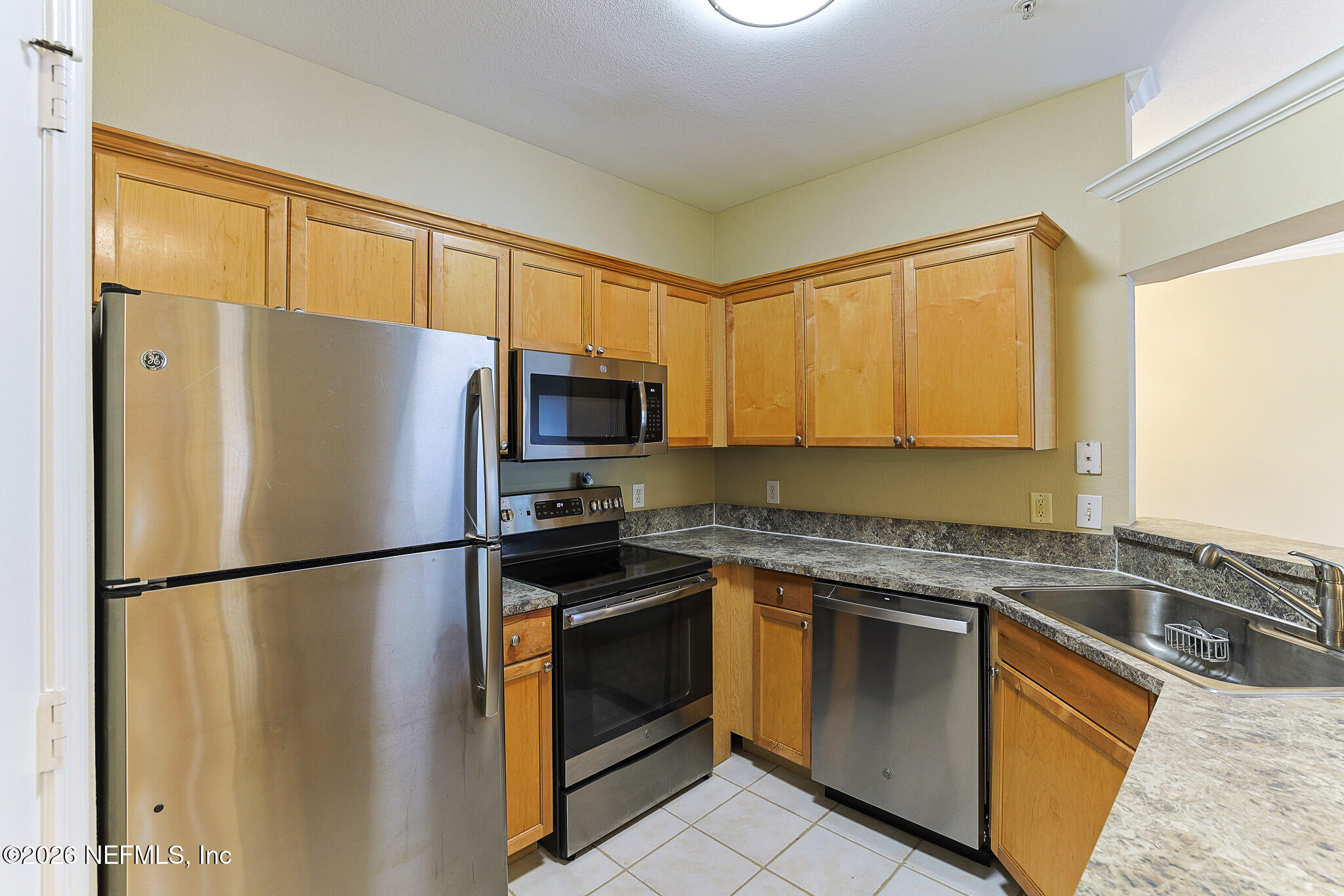 10961 Burnt Mill Road, Unit 426 Jacksonville, FL 32256 - Photo 3 of 24 a kitchen with a refrigerator sink and microwave