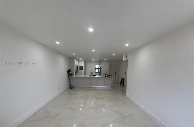 an empty room with windows and wall